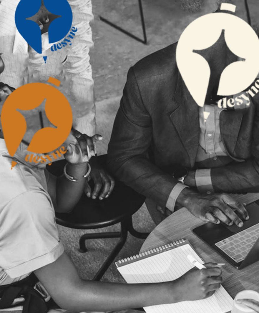 Colleagues working at a table, with Desyne logo marks in place of their heads