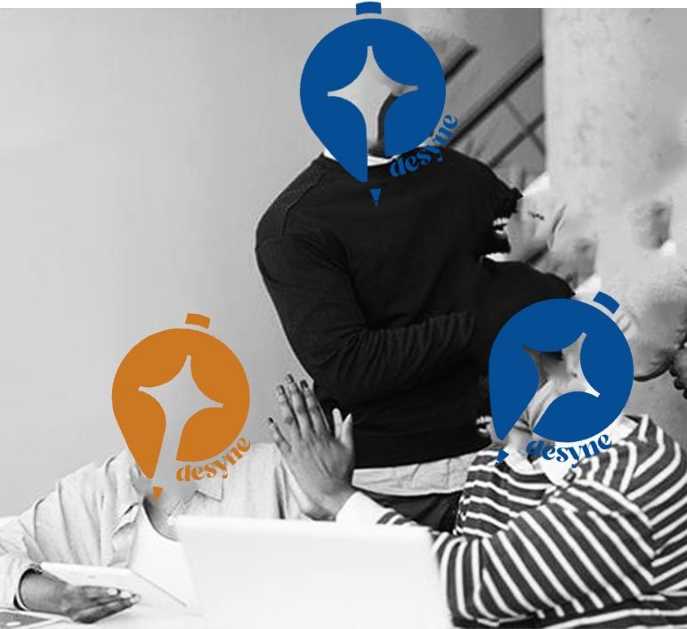 Colleagues celebrating at work, with Desyne logo marks in place of faces